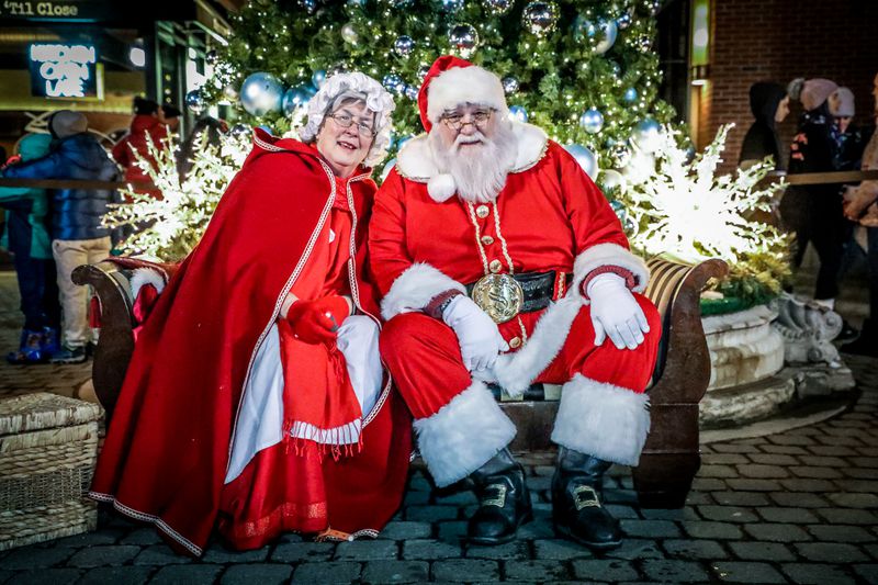 Mr. and Mrs. Claus smiling at the camera